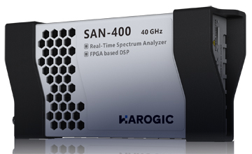 A hand holding a black box with ports Description automatically generated